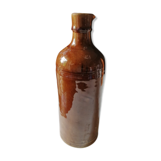 Old bottle in varnished ground.