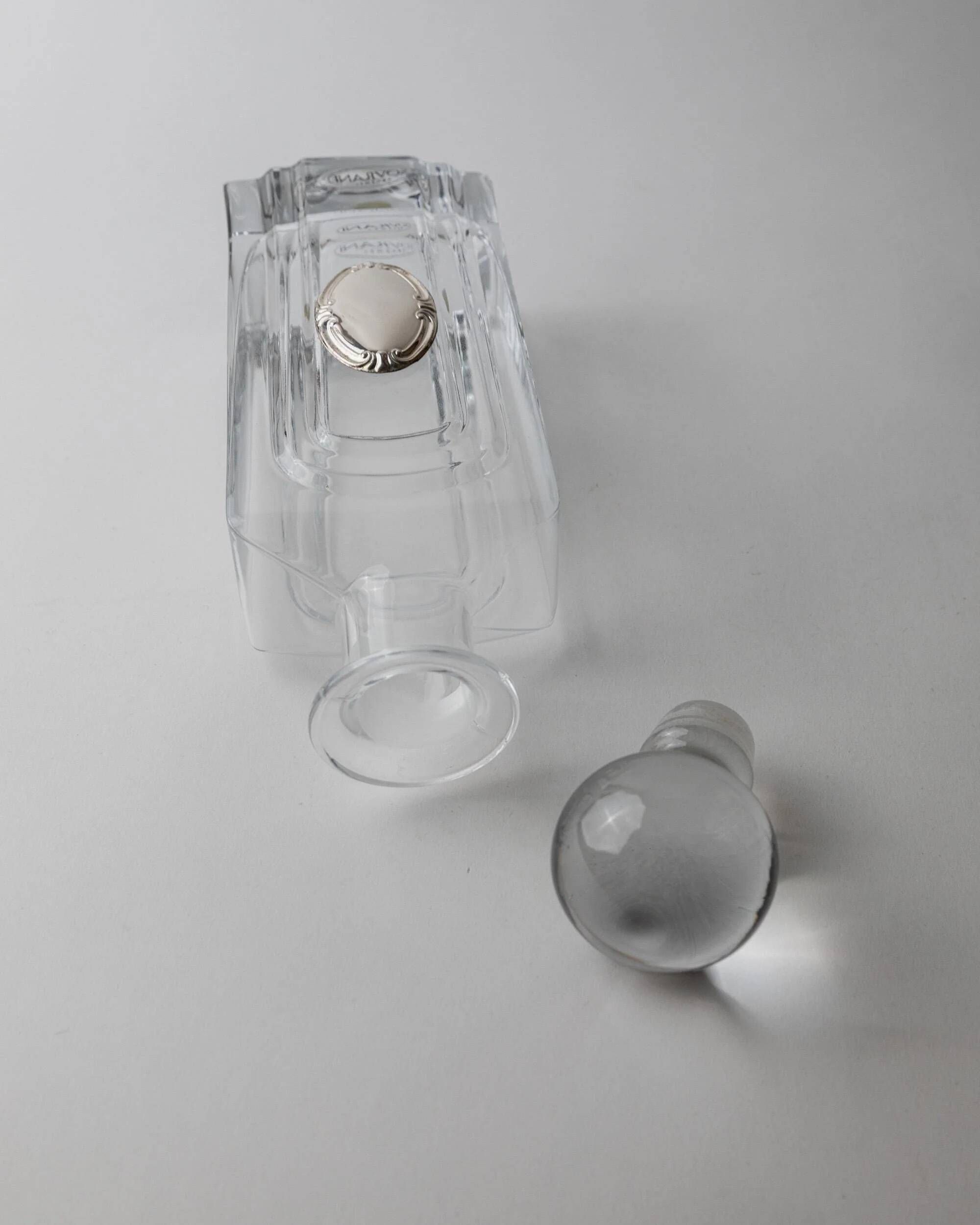 Vintage glass decanter from the 1980s, transparent glass with a silver plate and spherical stopper.