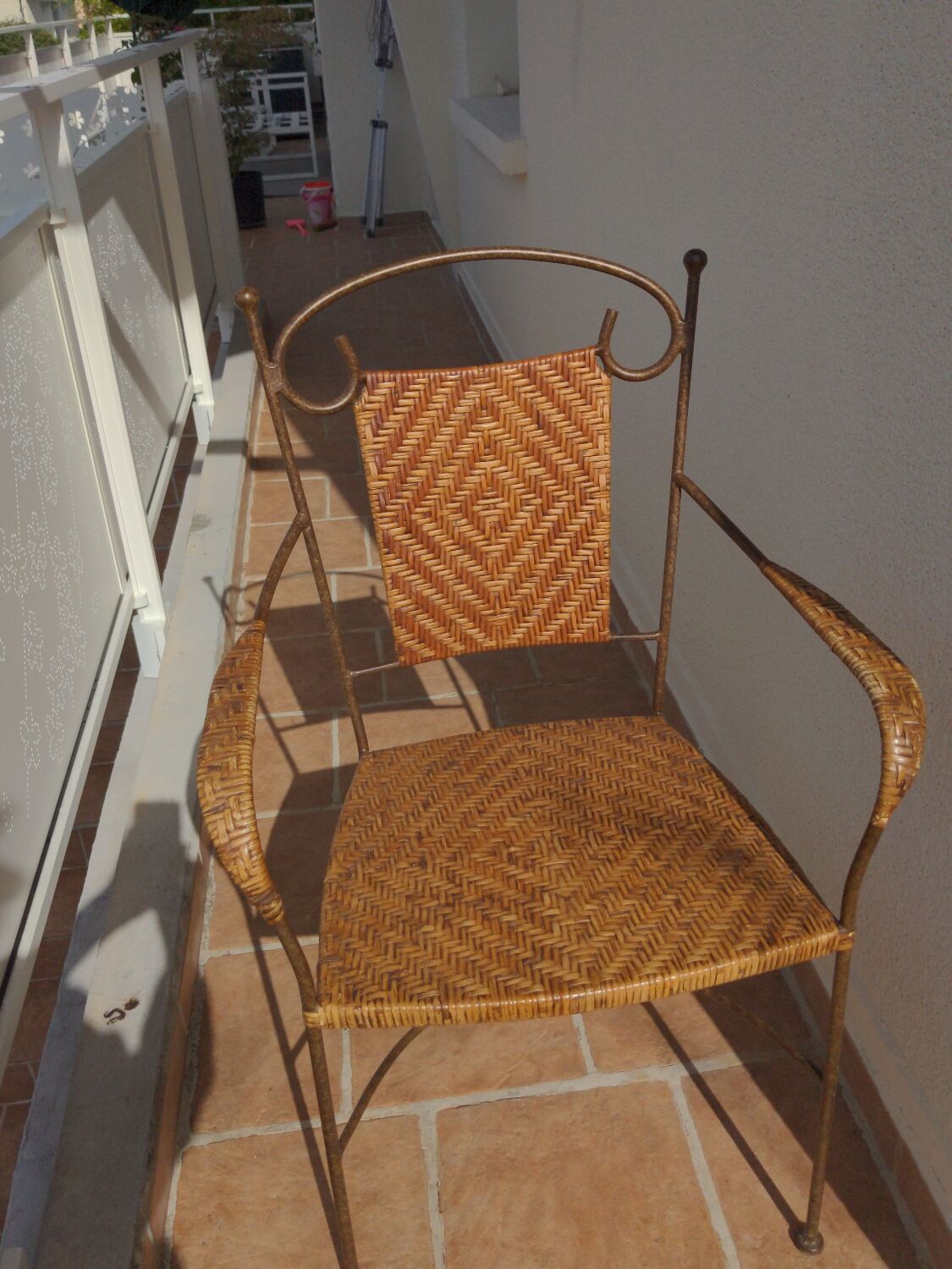 Wicker armchair and wrought iron