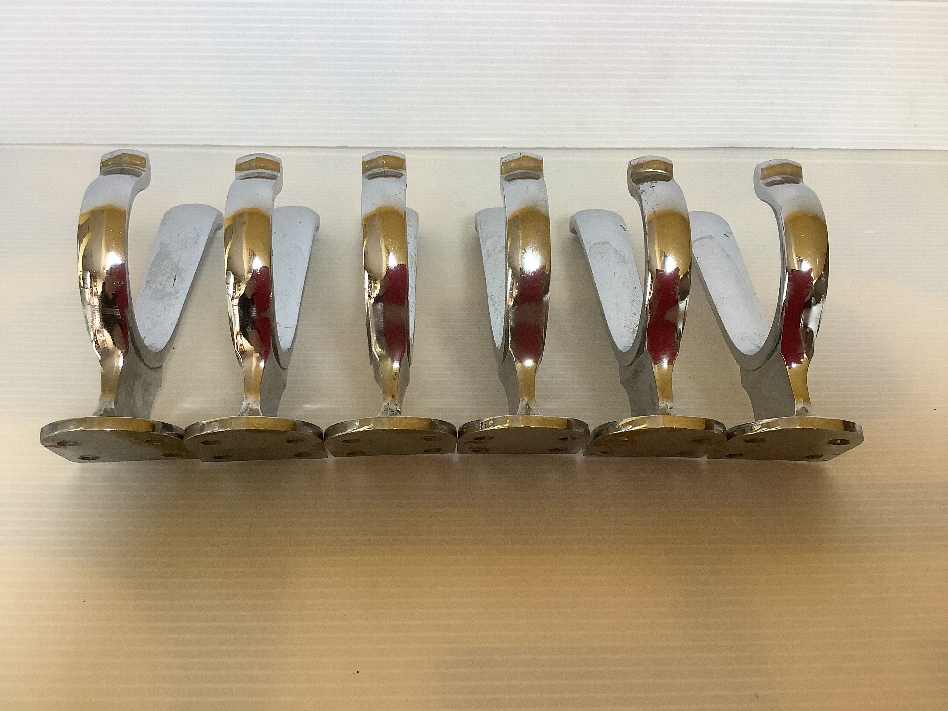 Six old chrome-plated metal hooks
