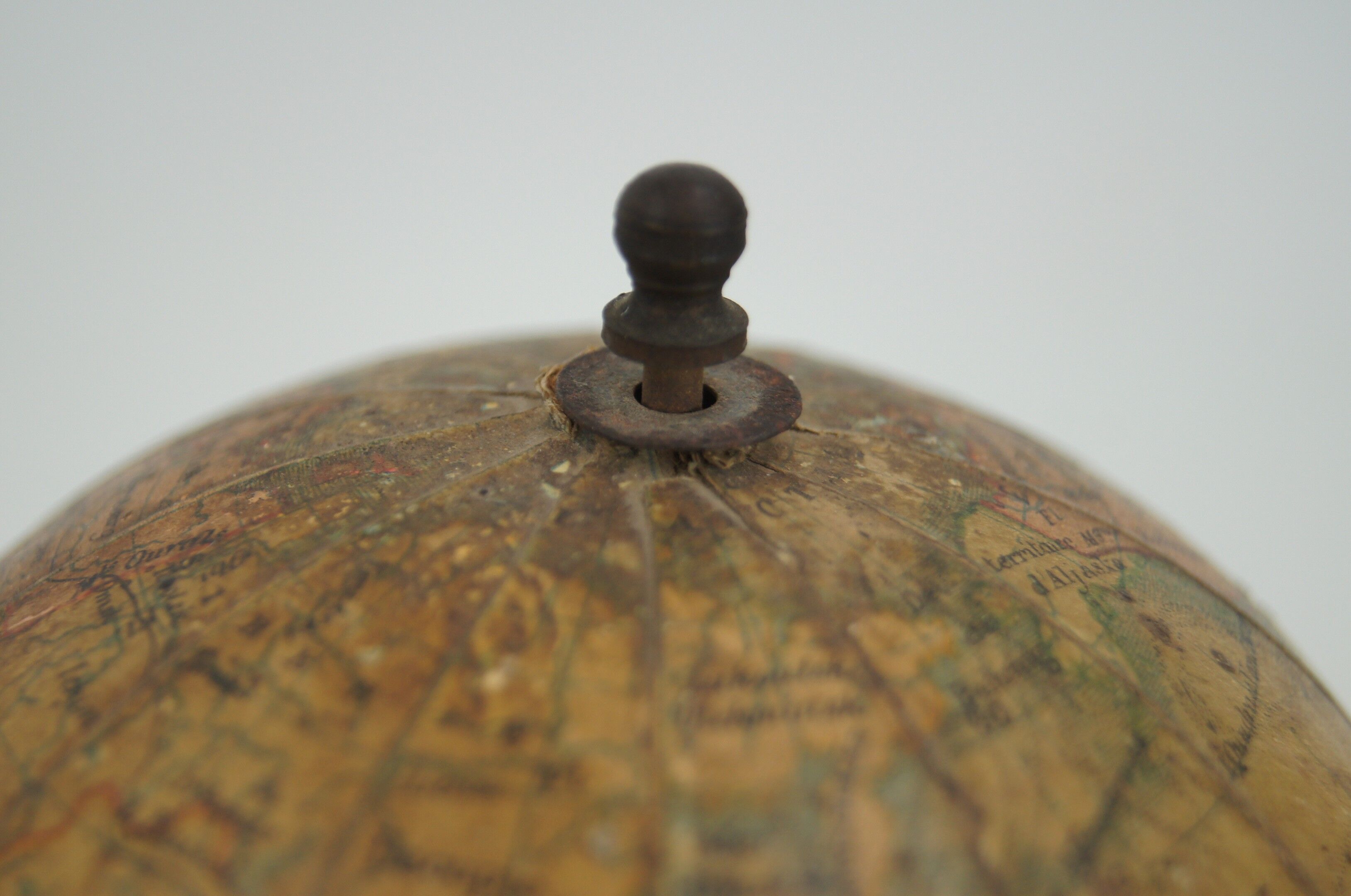 Globe on turned and blackened wooden base