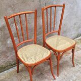 Pair of wooden and cane bistro chairs