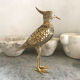Crested bird in golden brass