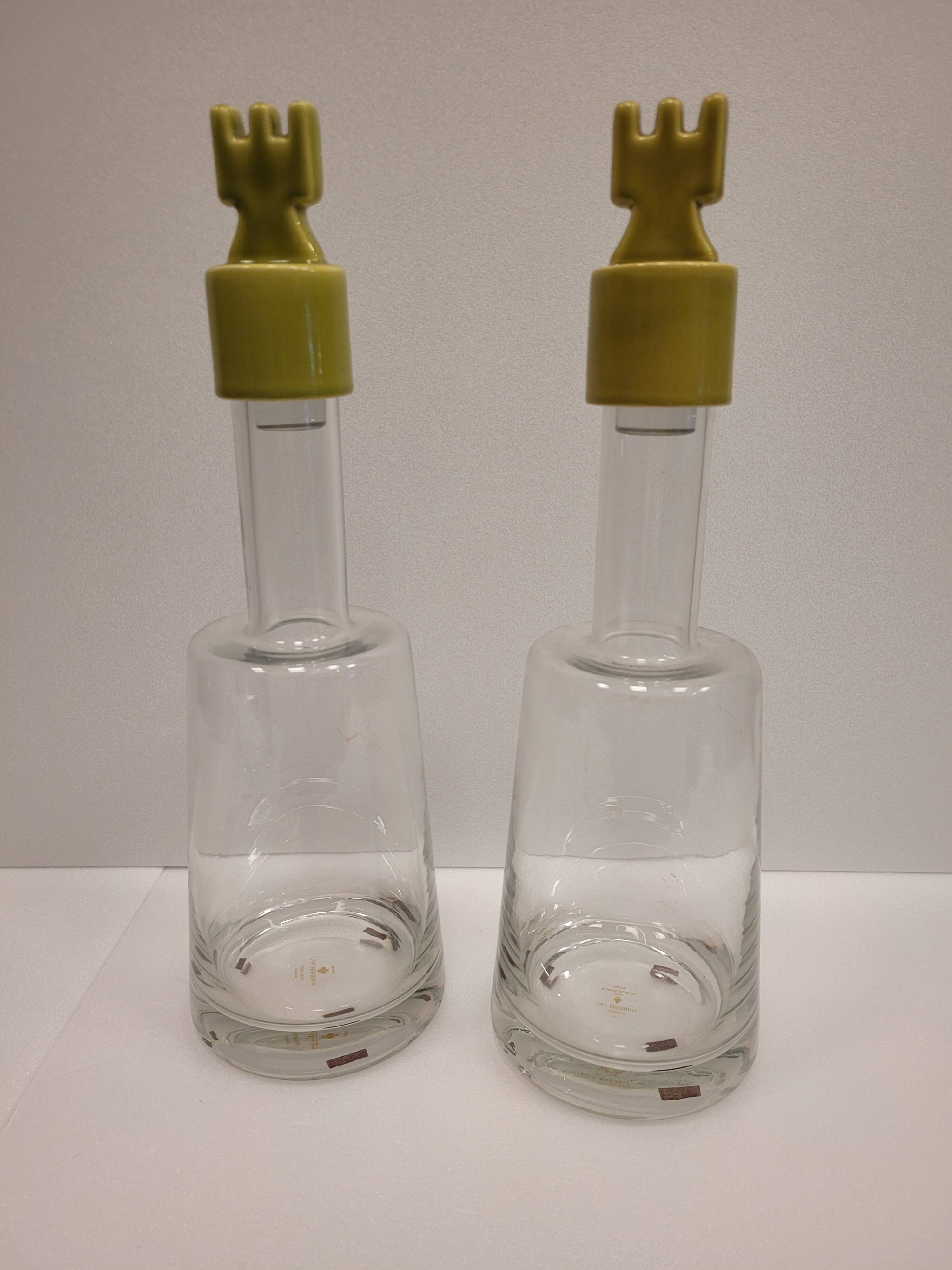 pair of decanters, bottles or jars, made in crystal with a ceramic tap enameled in green color