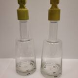 pair of decanters, bottles or jars, made in crystal with a ceramic tap enameled in green color