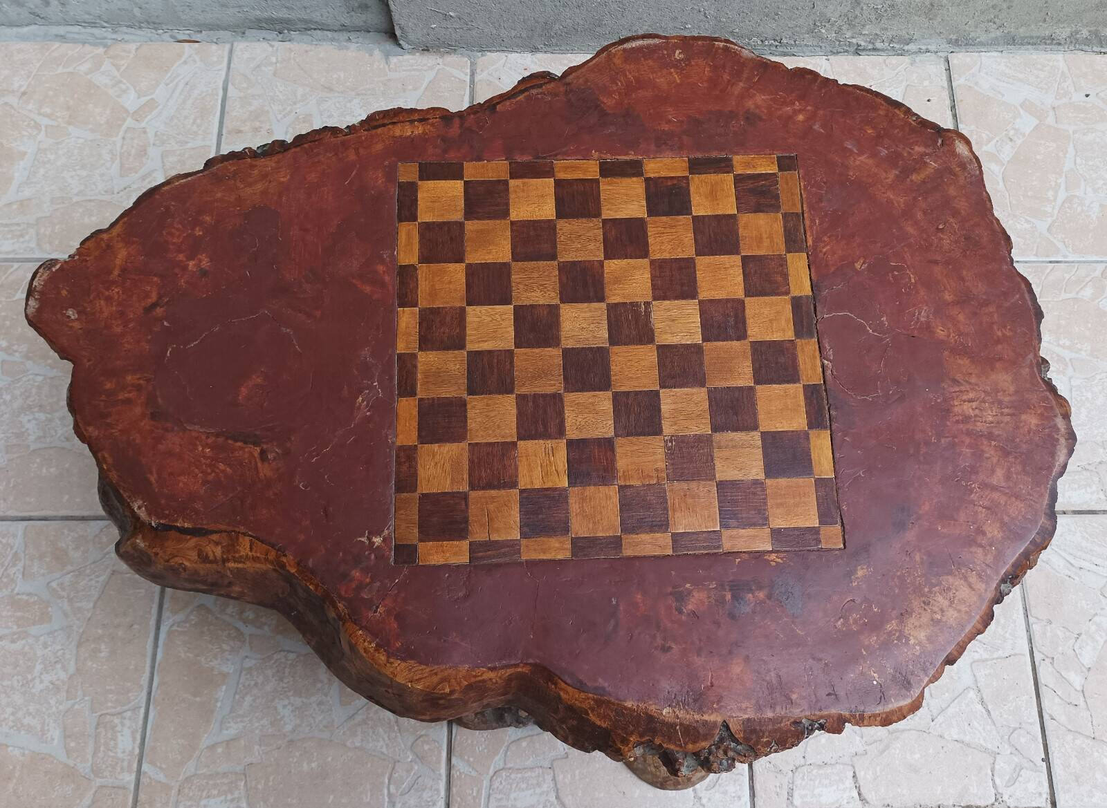 Brutalist chessboard coffee table made from tree stump.