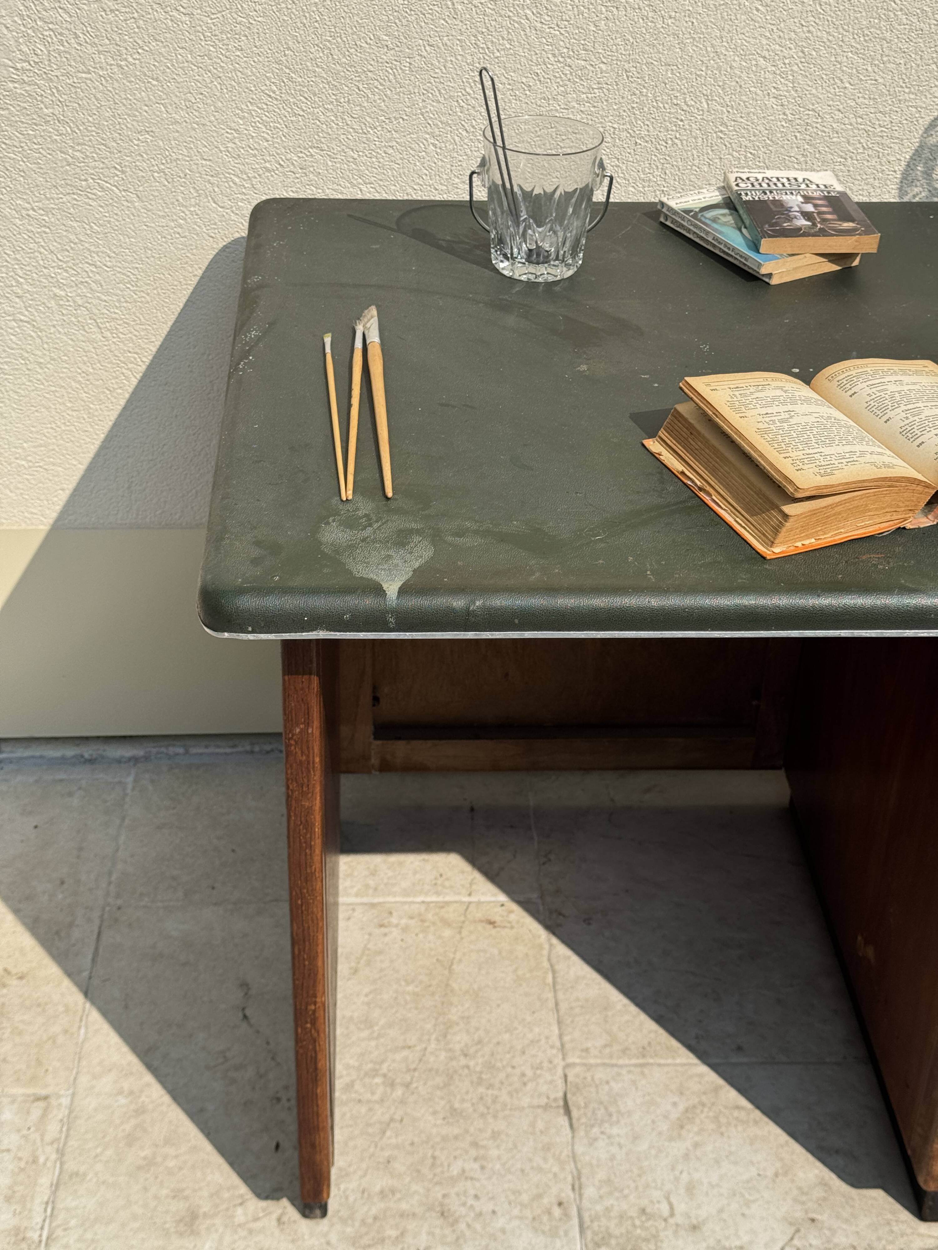 Modernist desk in wood and green moleskin upholstery