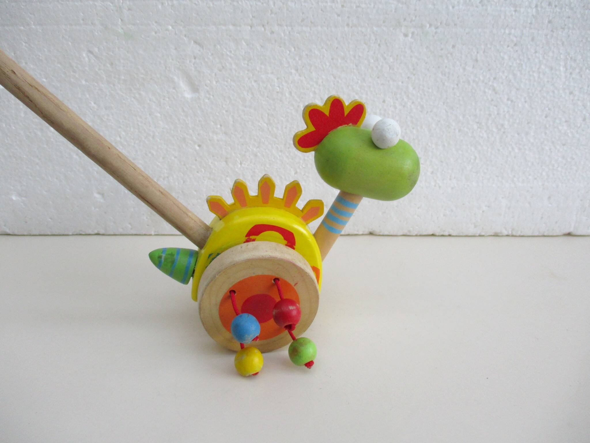 Push toy, wooden dinosaur. Brand: Bino