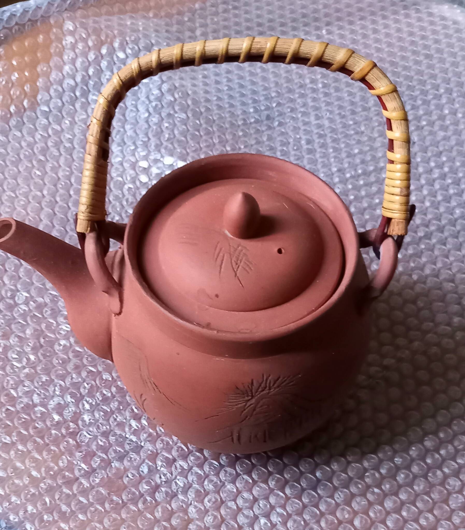 Terracotta and rattan teapot