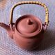 Terracotta and rattan teapot
