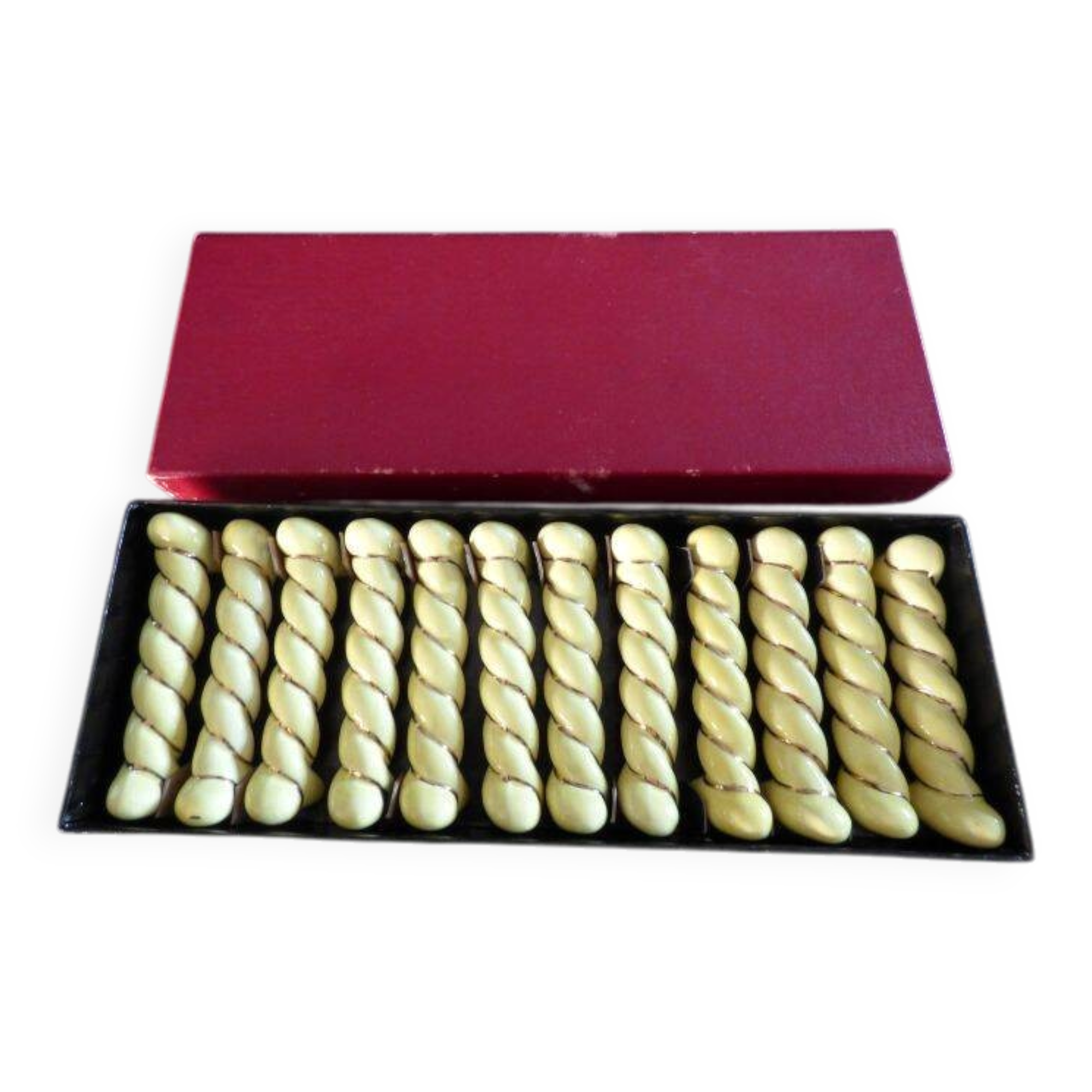 12 yellow and gold ceramic knife rests in their case from the 1950s.