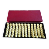 12 yellow and gold ceramic knife rests in their case from the 1950s.