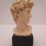 Small glass globe on base housing a figurine of “david”