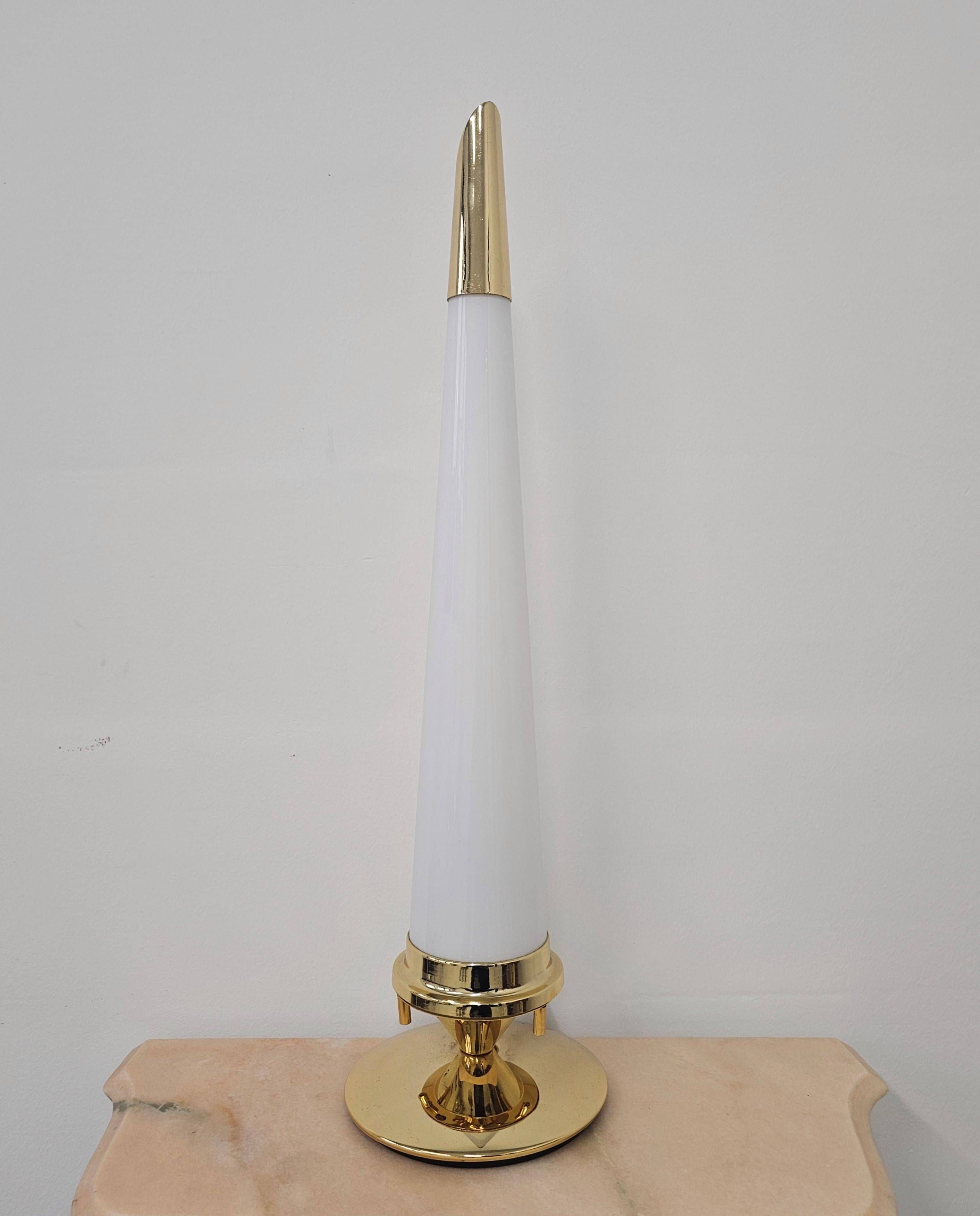 Pair of Hollywood Regency table lamps in brass with glass shades.