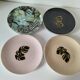 Set of 7 porcelain plates, gold foliage & jungle