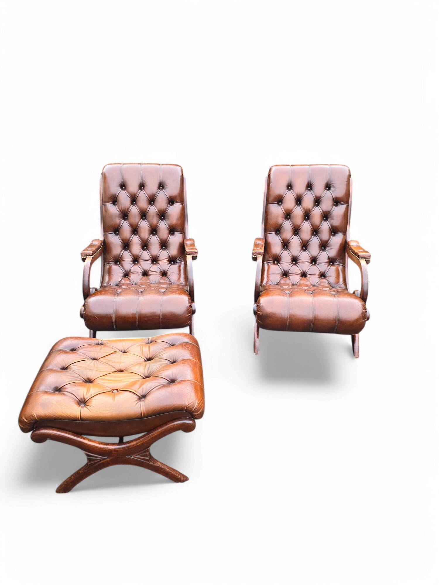 Pair of leather Chesterfields and footstools