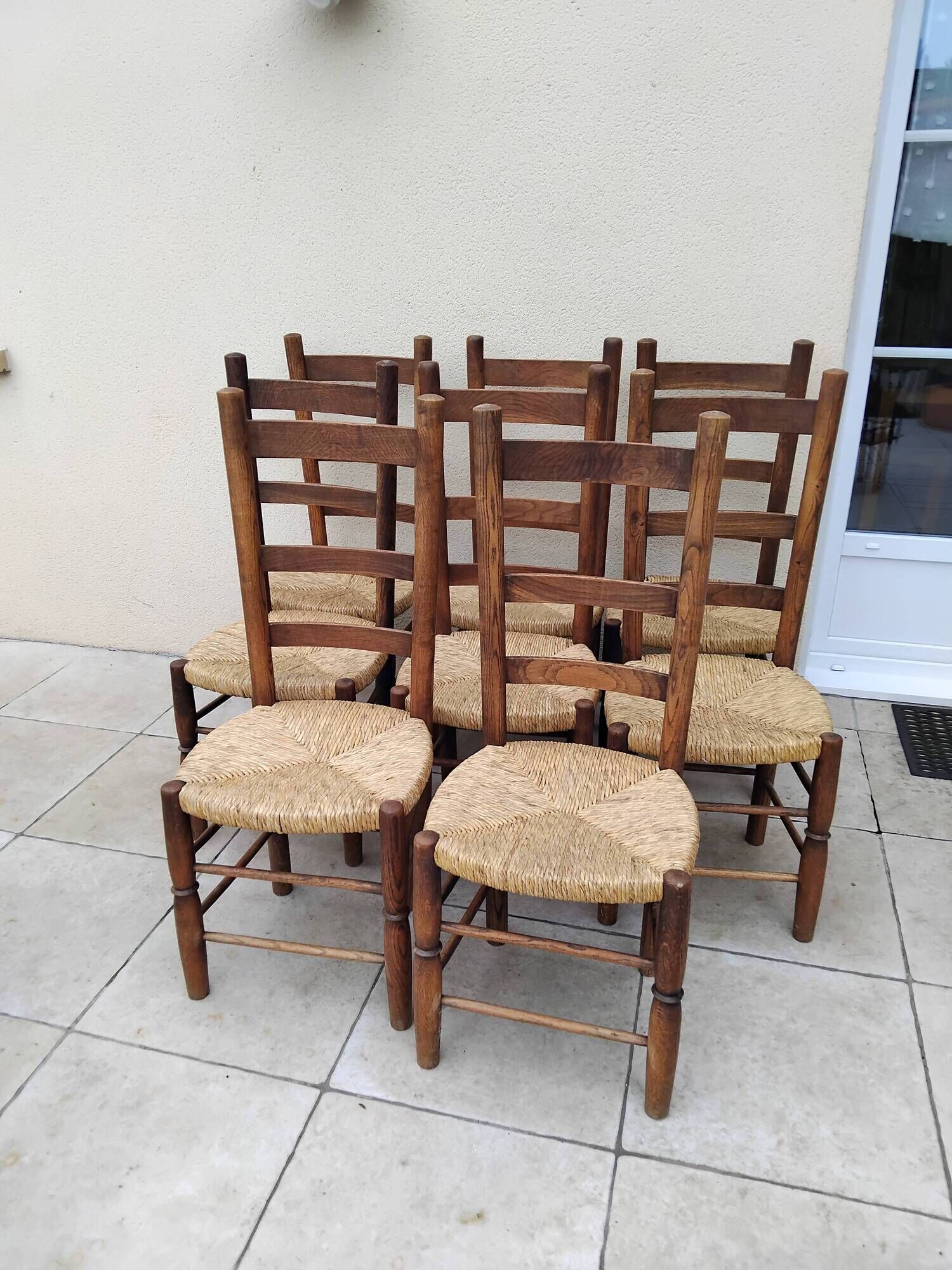 8 vintage straw chairs in the style of Charlotte Perriand.