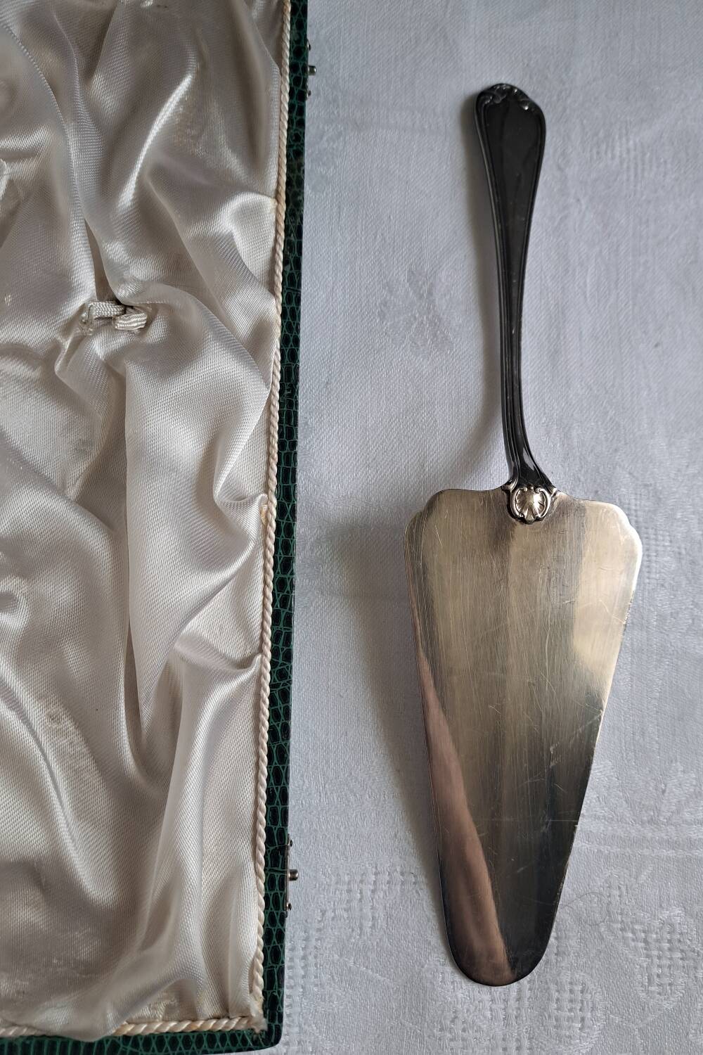 Silver metal cake peeler.