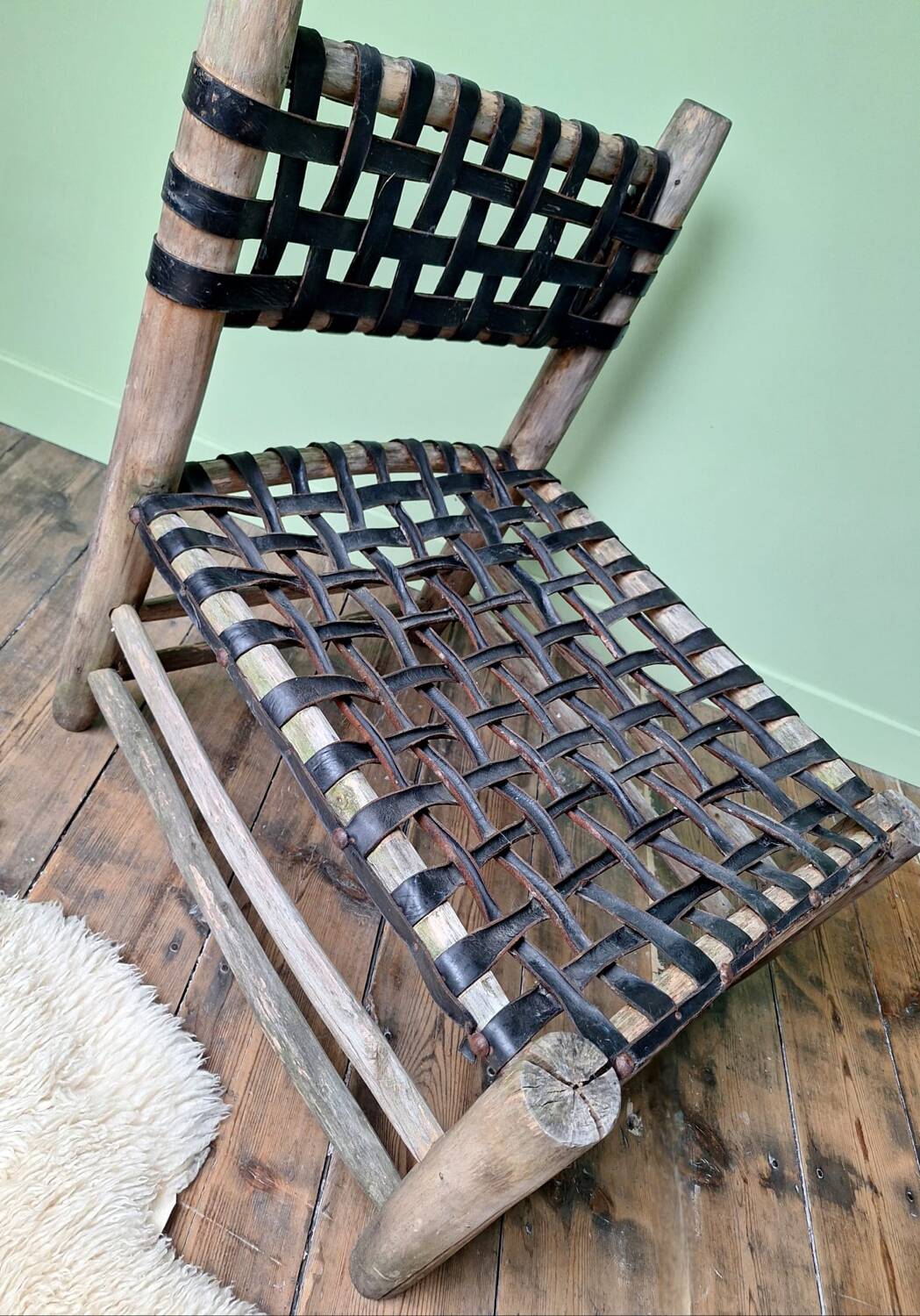 Vintage armchair in woven leather and wood