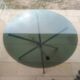 Round smoked glass table from the 70s. Foldable stainless steel legs.
