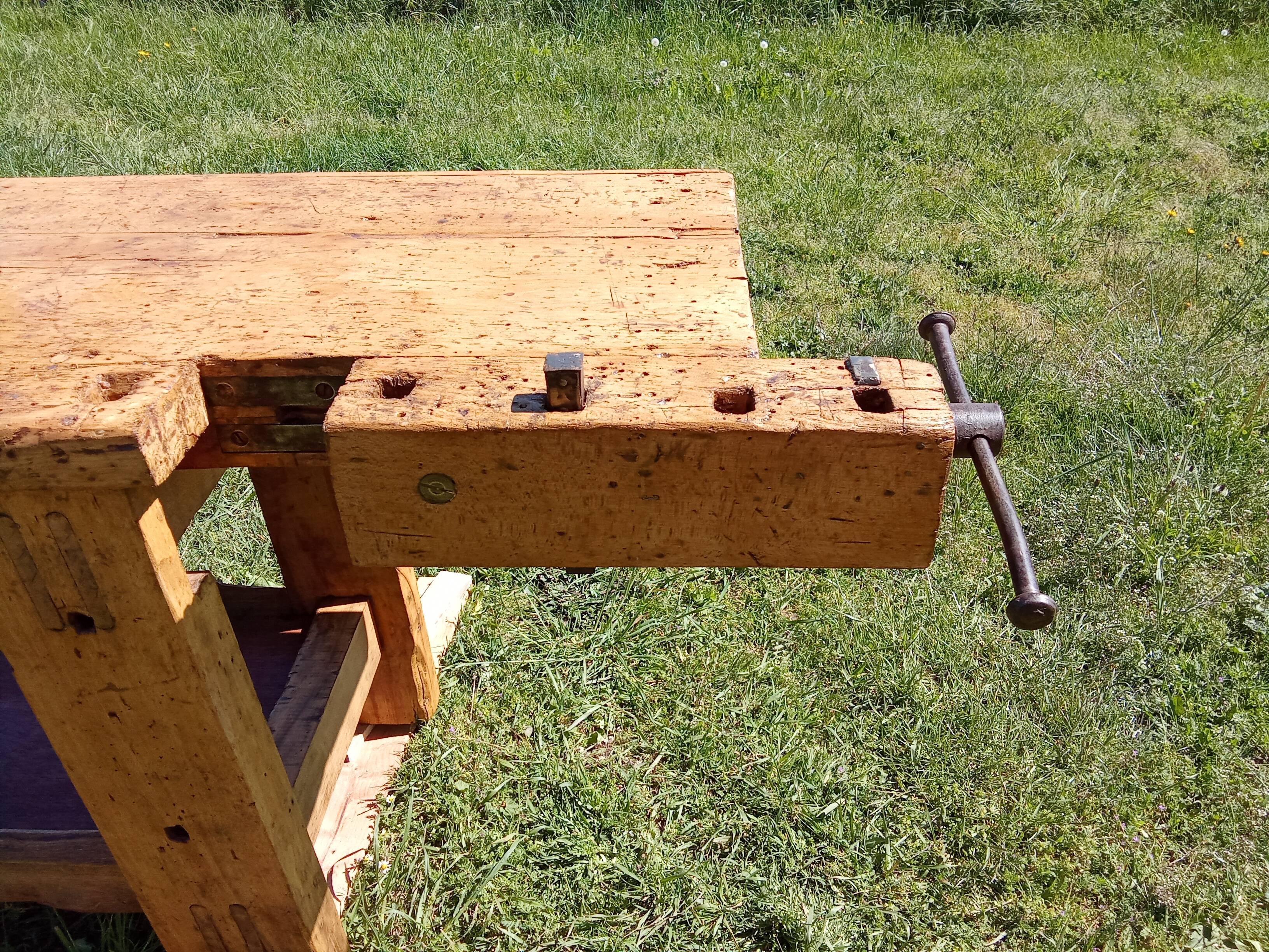 Old solid wood carpenter's bench with 2 functional vices.