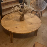 Large round antique coffee table made of raw solid wood.