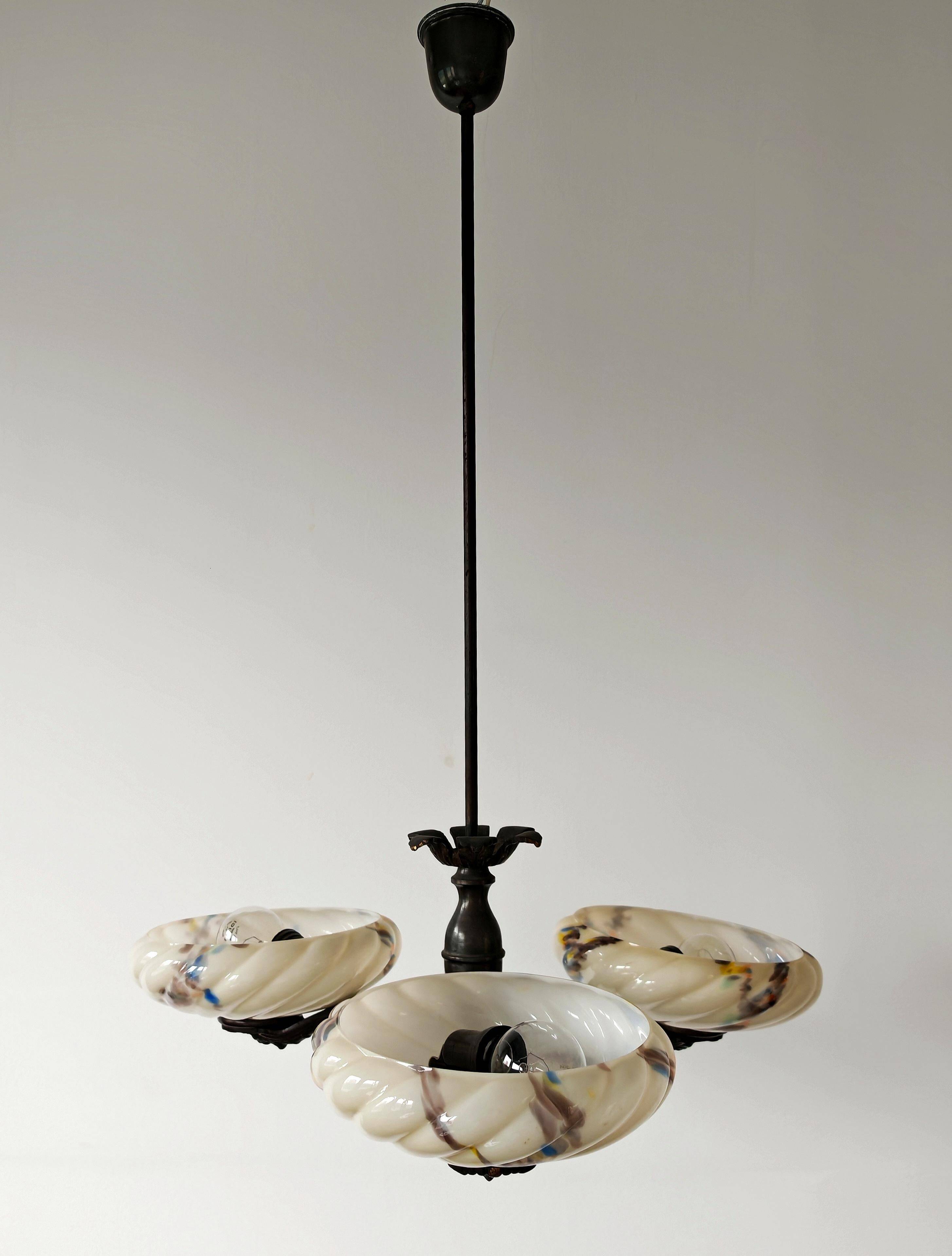 Art Deco bronze three-arm chandelier with marbled glass shades.