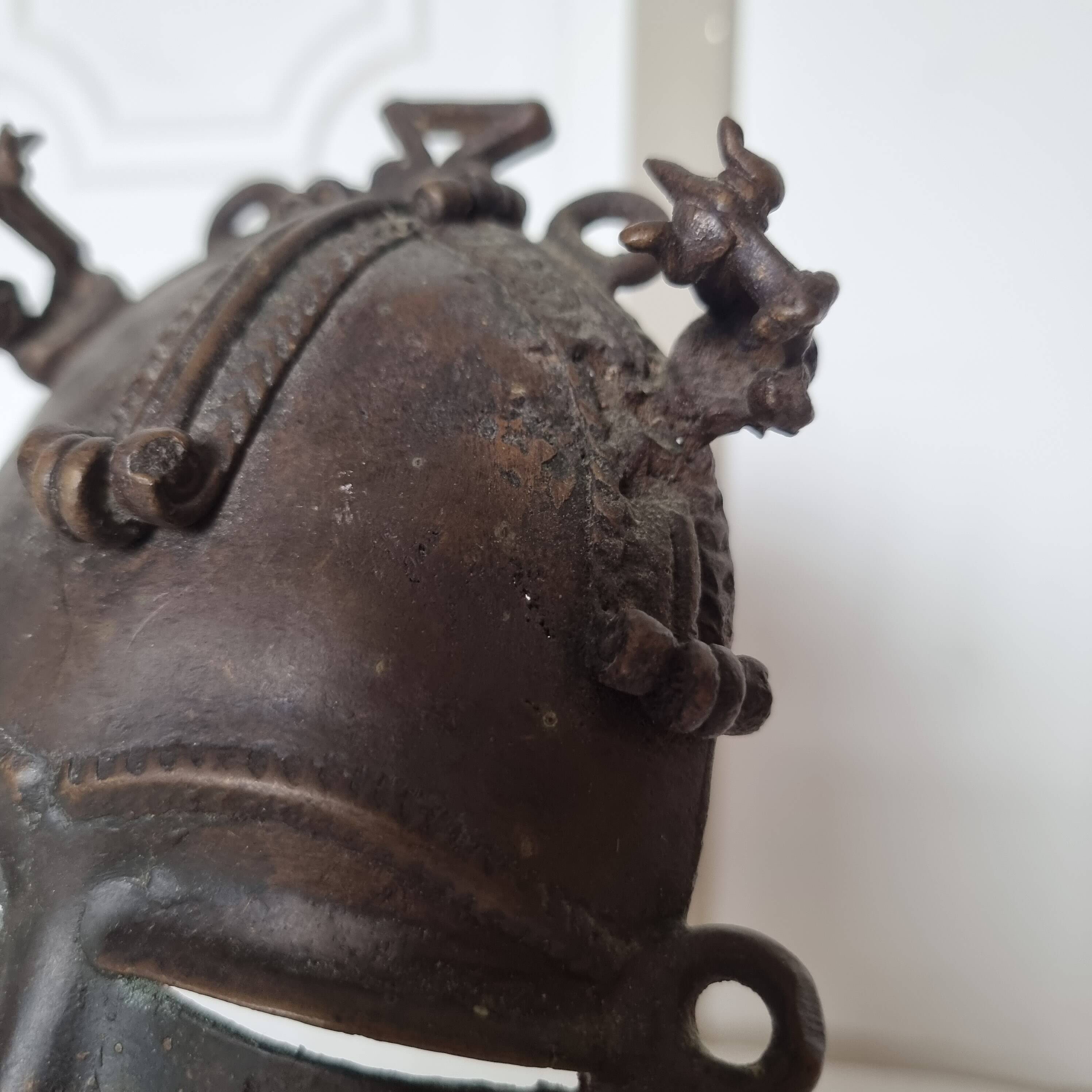 African bronze mask on pedestal, from Ivory Coast, dating
