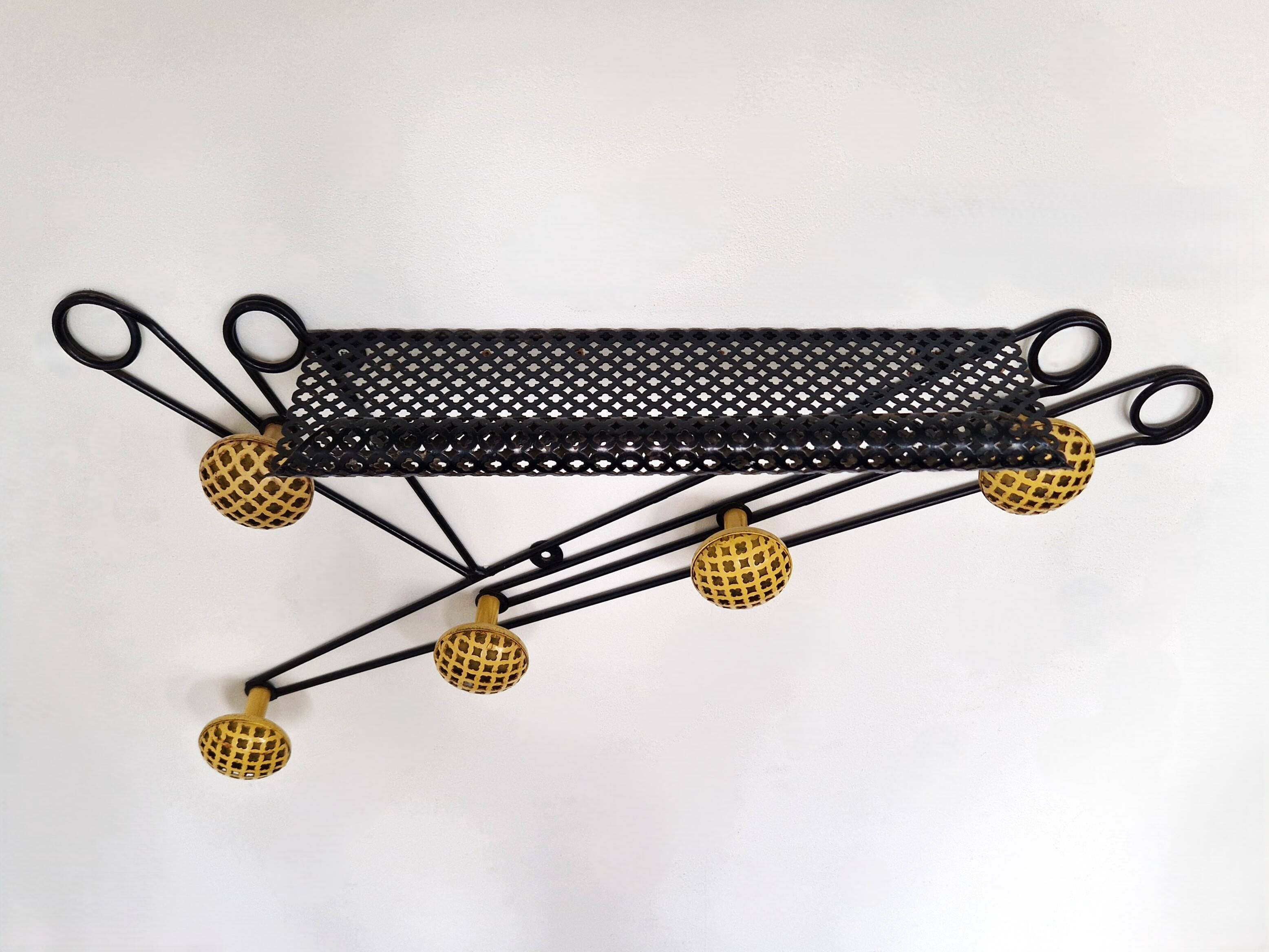 Black and yellow wall coat rack, France