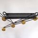Black and yellow wall coat rack, France