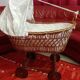 Vintage 1970s wicker cradle on wheels