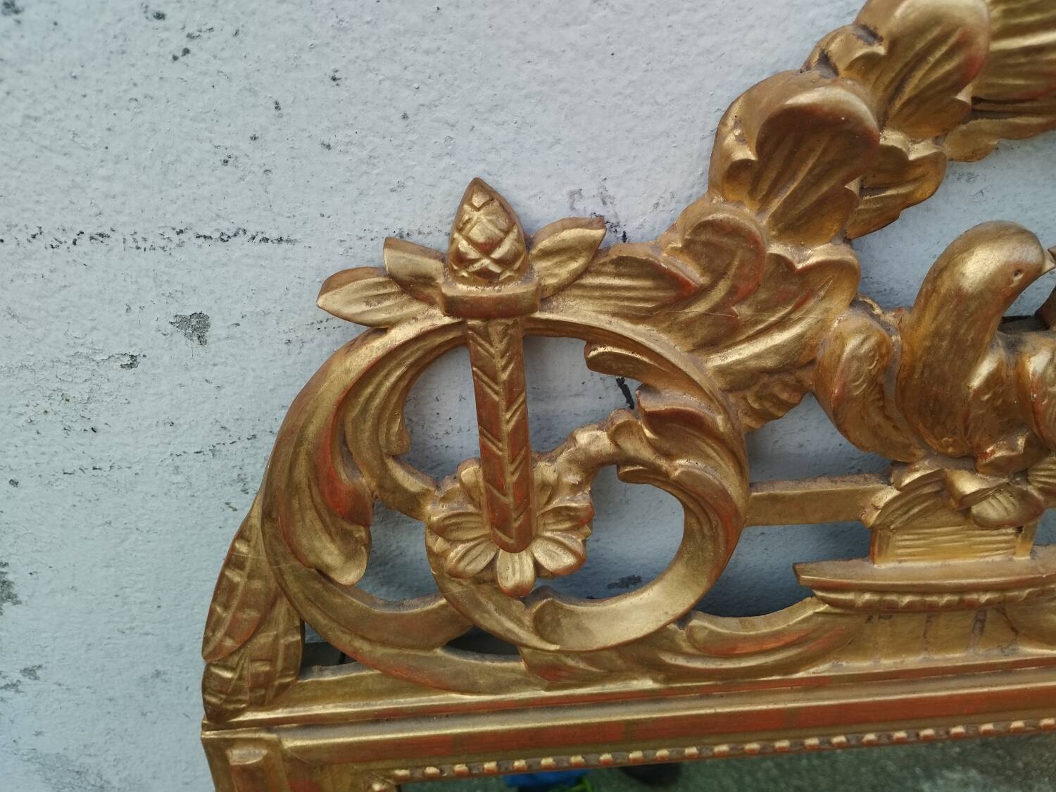 Antique gilded wooden mirror in Louis XVI style