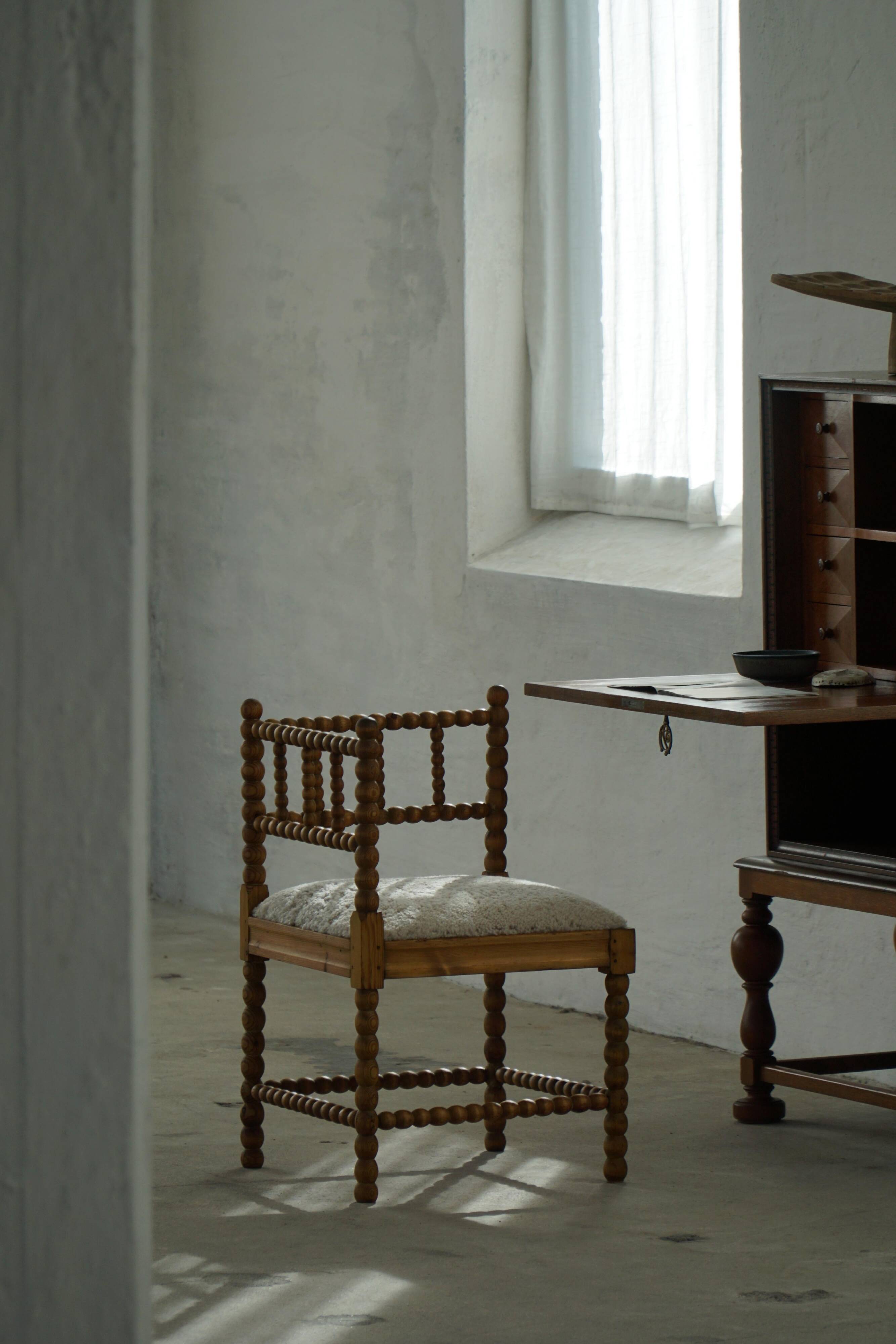 Antique French corner chair handcrafted with lamb's wool, early 20th century.