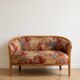 Two-seater banquette in Louis XV style made of wood and floral fabric.