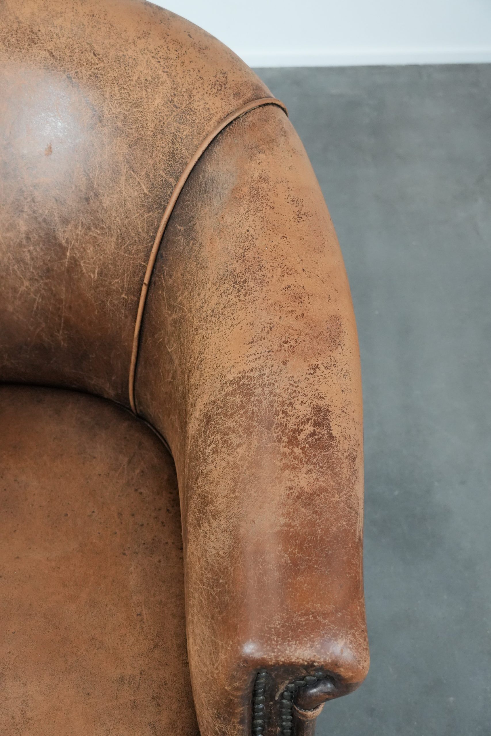 Vintage sheepskin club armchair with character and a beautiful patina