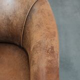 Vintage sheepskin club armchair with character and a beautiful patina
