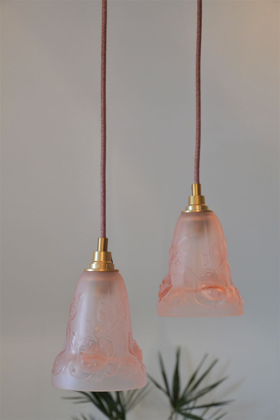 Pair of art nouveau style pendants in pink molded glass