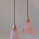 Pair of art nouveau style pendants in pink molded glass