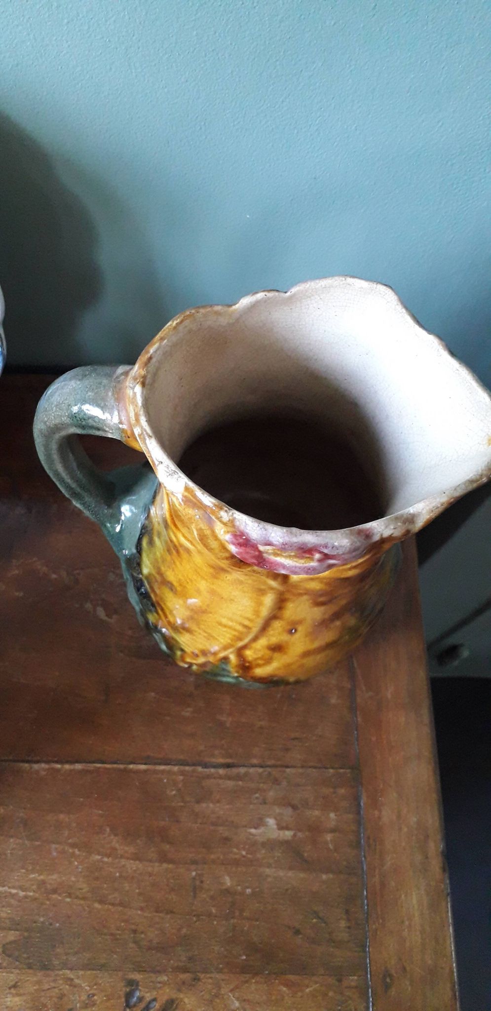 Vintage barbotine pitcher with floral decoration