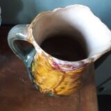 Vintage barbotine pitcher with floral decoration