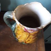 Vintage barbotine pitcher with floral decoration
