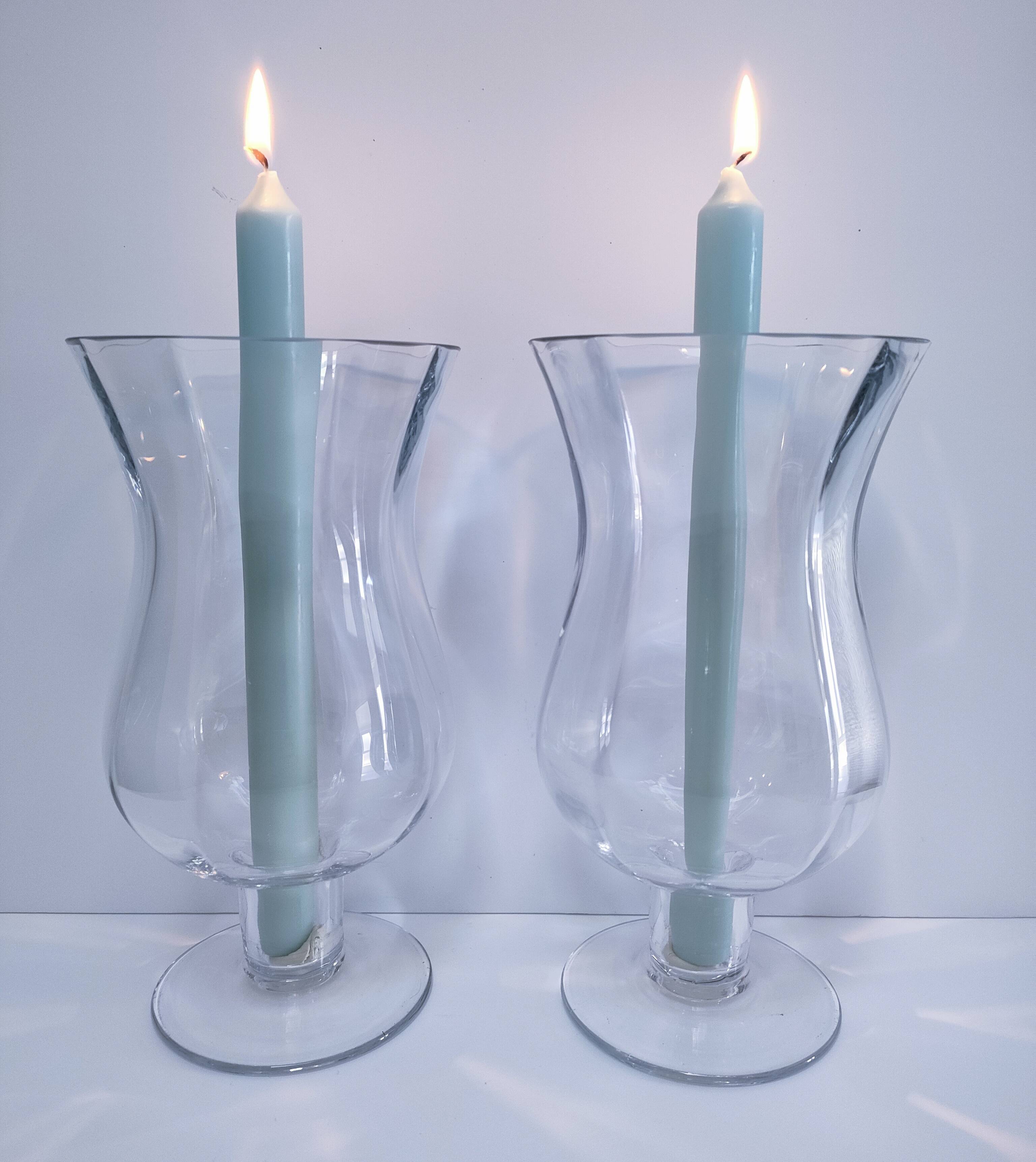 Pair of tall clear glass candlesticks from the early 20th century