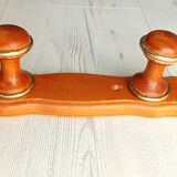 Wall-mounted coat rack in wood and brass
