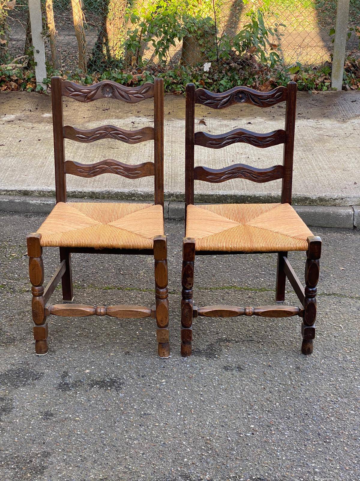 2 solid wood chairs with carved rush seats