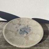 Round ethnic handmade fish dish