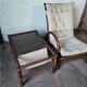 Relaxed armchair in bamboo and rattan with its small side table. Beige linen cushion.