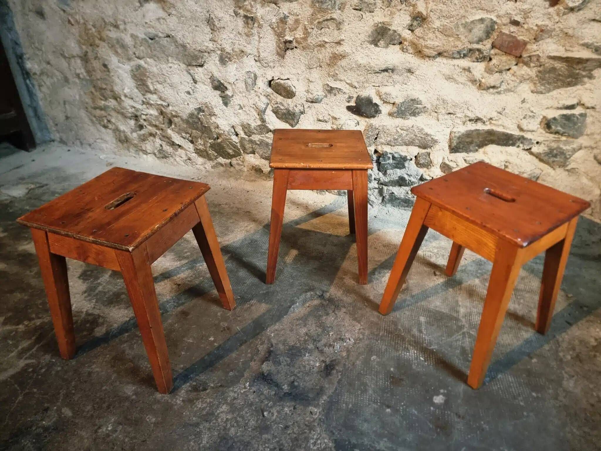 Set of 3 vintage French wooden stools from the 1950s.
