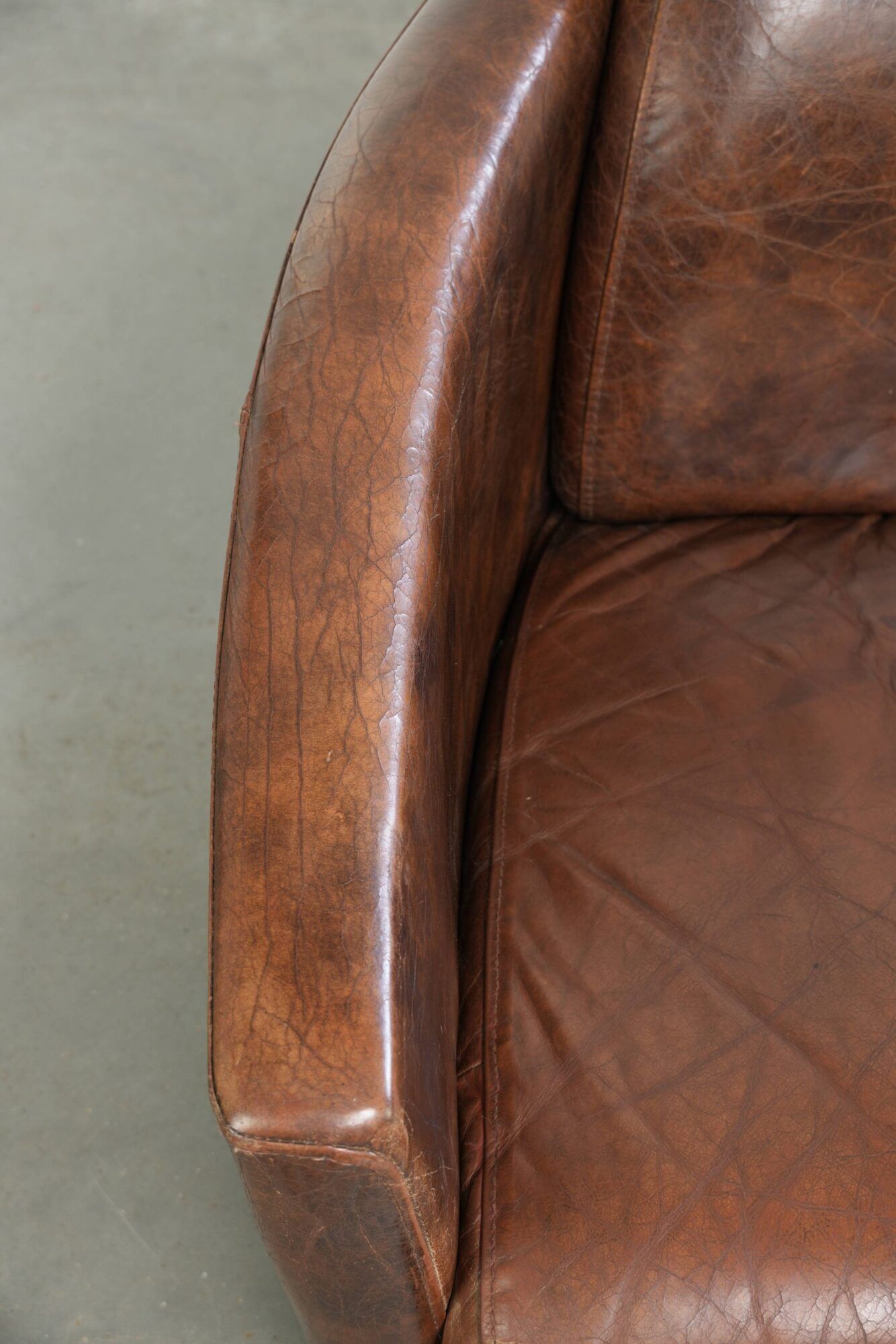 Cowhide armchair in Aviator design in a warm brown colour