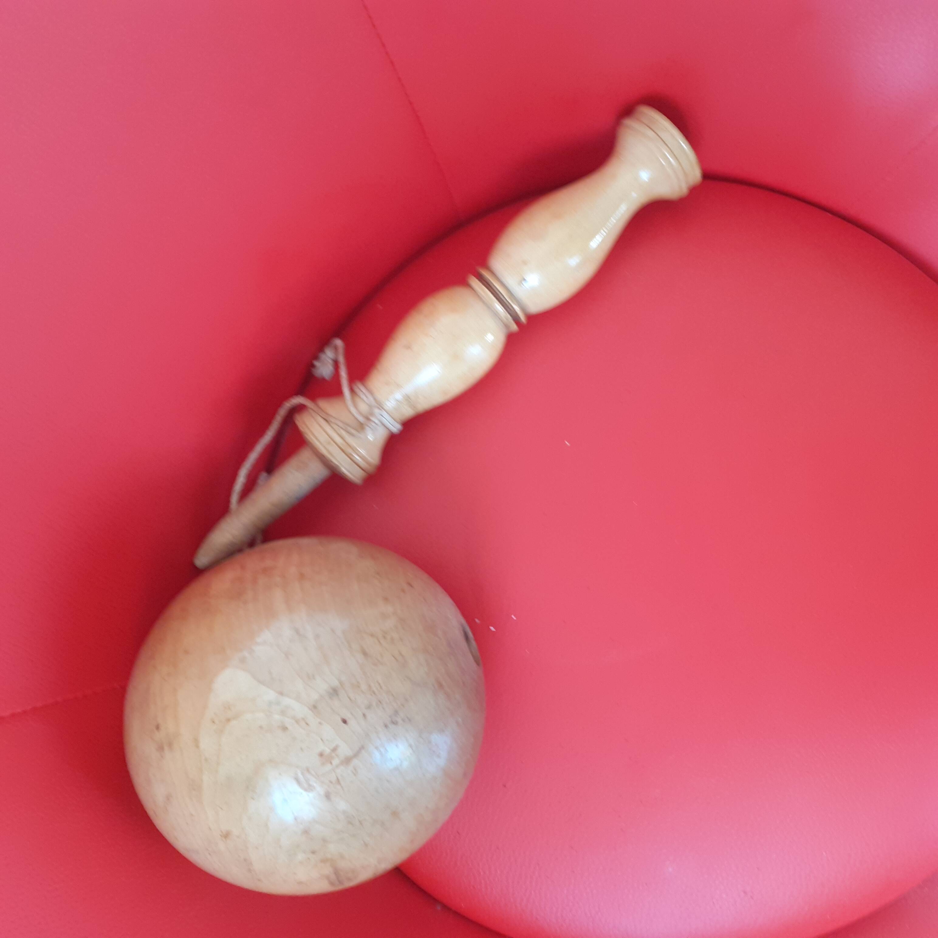 Large cup-and-ball cup in light wood.