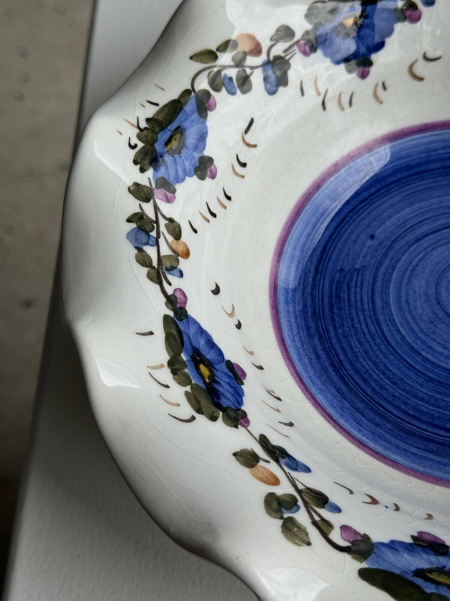 Small hand-painted earthenware salad bowl with garland of blue flowers, mark below